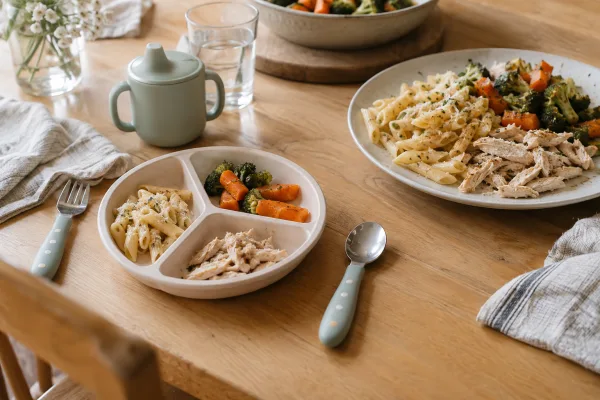 A small child’s plate and an adult plate set together for a family meal