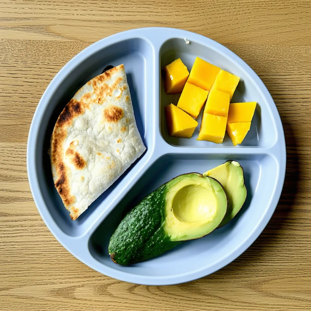 Cheese quesadilla triangles, avocado slices and mango cubes